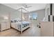 Bright bedroom with a four-poster bed, ceiling fan, and a view to the outside at 10121 Beachwalk Dr, Englewood, FL 34223