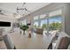 Bright dining area with a view of the pool area and modern table, creating an inviting atmosphere at 10121 Beachwalk Dr, Englewood, FL 34223