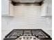 Close up of a stovetop with white backsplash at 10121 Beachwalk Dr, Englewood, FL 34223