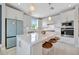 Stylish kitchen features a large island, white cabinets, stainless steel appliances, and modern lighting at 10121 Beachwalk Dr, Englewood, FL 34223