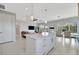 Open-concept living room features neutral tones, recessed lighting, and tile flooring for a contemporary feel at 10121 Beachwalk Dr, Englewood, FL 34223