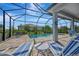 Sunny pool area featuring a sparkling pool and plenty of lounge chairs for relaxing by the water at 10121 Beachwalk Dr, Englewood, FL 34223
