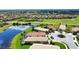 Single-Gathering home located on the water and backing up to a golf course with a circular driveway at 102 Mestre Pl, North Venice, FL 34275