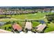 Beautiful aerial view of a home on a golf course; it features a well-manicured lawn and a red tile roof at 102 Mestre Pl, North Venice, FL 34275