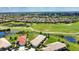 Beautiful aerial view of a single Gathering home on a golf course with mature landscaping and an orange tile roof at 102 Mestre Pl, North Venice, FL 34275