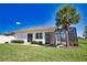 Home's exterior showcasing a patio with a tropical palm tree at 102 Mestre Pl, North Venice, FL 34275