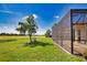 A manicured lawn showcases the screened in patio, and scenic golf course at 102 Mestre Pl, North Venice, FL 34275