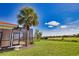 Landscaped yard and patio with tropical palm tree and view at 102 Mestre Pl, North Venice, FL 34275