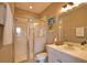 Well-lit bathroom showcasing a glass-enclosed shower, modern fixtures, and ample vanity storage space at 102 Mestre Pl, North Venice, FL 34275