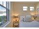 A light-filled bedroom features ample windows, and minimalist decor, offering a comfortable and serene retreat at 102 Mestre Pl, North Venice, FL 34275