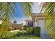 Beautiful home with lush landscaping, charming exterior details, and a well-maintained front yard at 102 Mestre Pl, North Venice, FL 34275