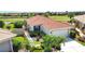 Aerial view of home showcasing red tile roof, attached garage, and lush landscaping at 102 Mestre Pl, North Venice, FL 34275