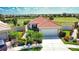 Aerial view of a lovely home with a terra cotta roof, meticulous landscaping, and attached garage at 102 Mestre Pl, North Venice, FL 34275