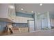 Efficient kitchen space featuring bright cabinets and a functional layout, designed for easy access to all appliances at 102 Mestre Pl, North Venice, FL 34275