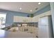 Well-lit kitchen featuring white cabinets, modern appliances, and a functional layout for easy meal preparation at 102 Mestre Pl, North Venice, FL 34275