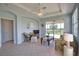 Inviting living room featuring tile floors, ceiling fan, and access to the lanai at 102 Mestre Pl, North Venice, FL 34275