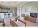 Open-concept living room with a kitchen view and comfortable seating arrangement with tile flooring throughout the space at 102 Mestre Pl, North Venice, FL 34275