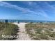 A panoramic view of Manasota Beach, showcasing sandy shores, blue waters, and clear skies at 10209 Fiddlewood Dr, Venice, FL 34293