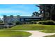 Signage for Sarasota National community with lush landscaping and clear blue skies at 10209 Fiddlewood Dr, Venice, FL 34293