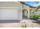 The house features a covered porch with seating, framed by elegant arched columns at 10209 Fiddlewood Dr, Venice, FL 34293