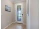 The entryway features an elegant glass-paneled front door and neutral tile flooring at 10209 Fiddlewood Dr, Venice, FL 34293
