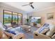 Open concept living room featuring stylish furnishings and seamless access to the screened lanai and pool at 10209 Fiddlewood Dr, Venice, FL 34293
