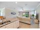 Open-concept living space with view of the pool and sliding glass doors at 10209 Fiddlewood Dr, Venice, FL 34293