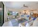 Inviting living room boasts a modern ceiling fan, comfortable seating, and seamlessly connects to an open kitchen area at 10209 Fiddlewood Dr, Venice, FL 34293