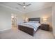 Relaxing bedroom with soft lighting, a ceiling fan, and a king-sized bed at 10209 Fiddlewood Dr, Venice, FL 34293