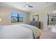 Bedroom featuring a dresser, a view to the lanai and access to the Primary bath at 10209 Fiddlewood Dr, Venice, FL 34293