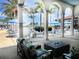 Covered outdoor seating area with comfortable chairs and tables overlooking the community pool at 10209 Fiddlewood Dr, Venice, FL 34293