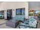 Inviting outdoor seating area with comfortable leaf-patterned furniture, a modern fire pit, and access to the clubhouse at 10209 Fiddlewood Dr, Venice, FL 34293