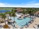 Aerial view of a luxurious pool with palm trees and lounge chairs in a beautiful community setting at 10209 Fiddlewood Dr, Venice, FL 34293