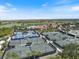Aerial view of tennis courts and surrounding community, showcasing the beautiful landscape and numerous courts available at 10209 Fiddlewood Dr, Venice, FL 34293