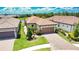 Aerial view of homes featuring tile roofs, landscape, and a paved driveway at 10410 Inglenook Ter, Palmetto, FL 34221