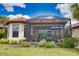 Well-kept backyard with a screened-in patio and lush, green landscaping at 10410 Inglenook Ter, Palmetto, FL 34221