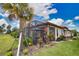 Beautiful backyard with mature landscaping, a patio, and well-maintained lawn at 10410 Inglenook Ter, Palmetto, FL 34221