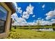 Landscaped backyard overlooking a serene pond, enhancing the home's appeal at 10410 Inglenook Ter, Palmetto, FL 34221