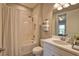 Bright bathroom with a shower-tub combination, decorative towels, and a sink at 10410 Inglenook Ter, Palmetto, FL 34221