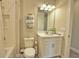 Bathroom features a shower-tub combination, modern hardware, and stacked decorative towels at 10410 Inglenook Ter, Palmetto, FL 34221