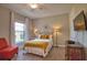 Bedroom with plush carpet, bright window, and comfortable seating area at 10410 Inglenook Ter, Palmetto, FL 34221