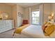 Bright bedroom with plush carpet, white dresser, and comfortable chair at 10410 Inglenook Ter, Palmetto, FL 34221