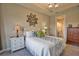 Bright bedroom with accent mirror and access to en-suite bathroom at 10410 Inglenook Ter, Palmetto, FL 34221