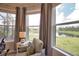 Sitting area with view of pond, lawn, and neighboring house at 10410 Inglenook Ter, Palmetto, FL 34221