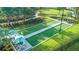 Aerial view of manicured bocce ball courts surrounded by lush landscaping and lounge areas at 10410 Inglenook Ter, Palmetto, FL 34221