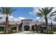Elegant clubhouse entrance surrounded by lush landscaping, creating a welcoming and sophisticated appeal at 10410 Inglenook Ter, Palmetto, FL 34221
