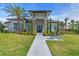 Exterior of a modern clubhouse with a well-manicured lawn and palm trees at 10410 Inglenook Ter, Palmetto, FL 34221