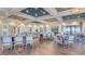 Open clubhouse with dining tables, wood floors, and comfortable seating areas at 10410 Inglenook Ter, Palmetto, FL 34221