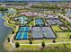 Aerial view showcasing community amenities including a pool, tennis courts, and green spaces, ideal for active living at 10410 Inglenook Ter, Palmetto, FL 34221