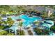 Resort-style community pool area with palm trees, cabanas, and lounge chairs, perfect for relaxation and socializing at 10410 Inglenook Ter, Palmetto, FL 34221